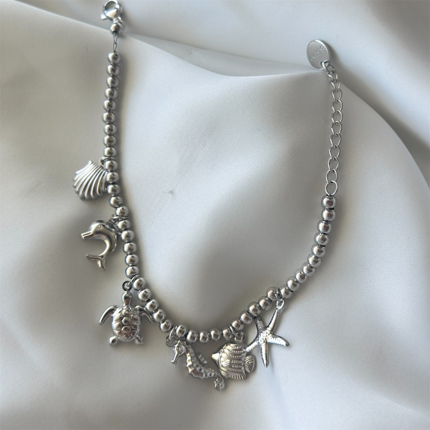 Bracciale in acciaio con sfere di 6 mm e ciondoli Marini sonaglio